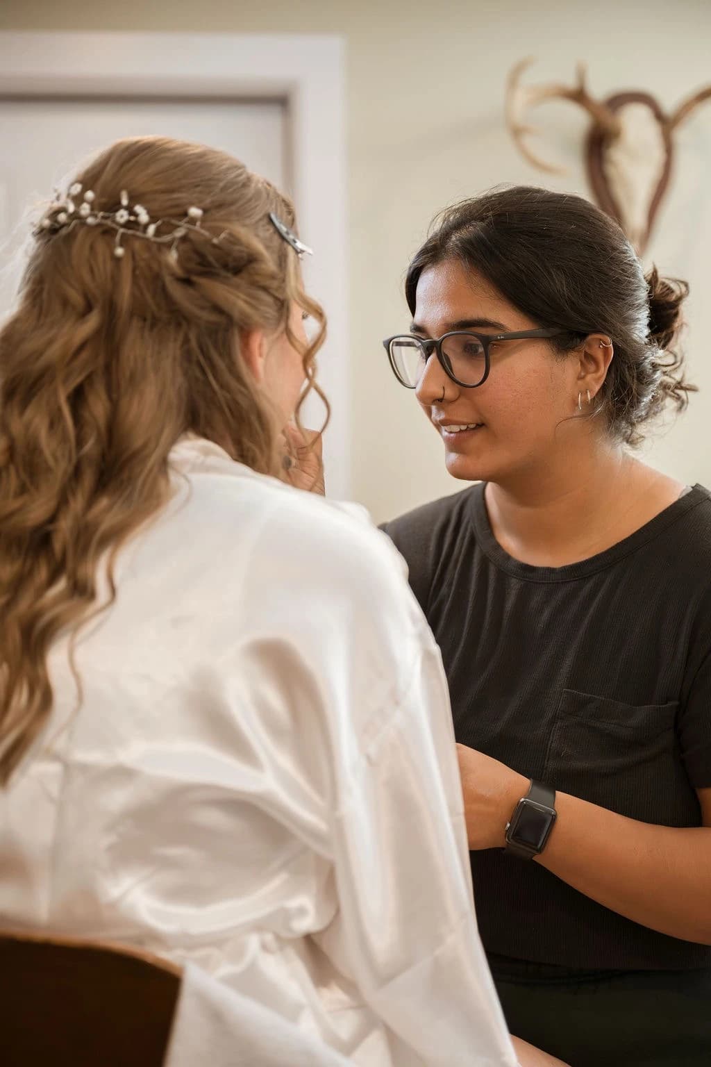 Sheena working with a bride during her makeup preparation.